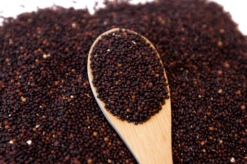 Raw brown seeds quinoa closeup isolated at white background