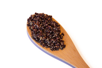 Raw brown seeds quinoa closeup isolated at white background