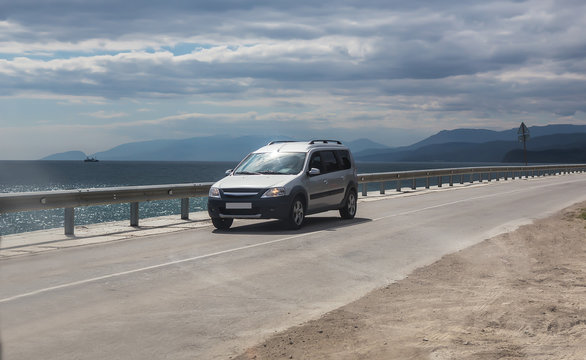 Minivan Moves On The Highway Along The Sea