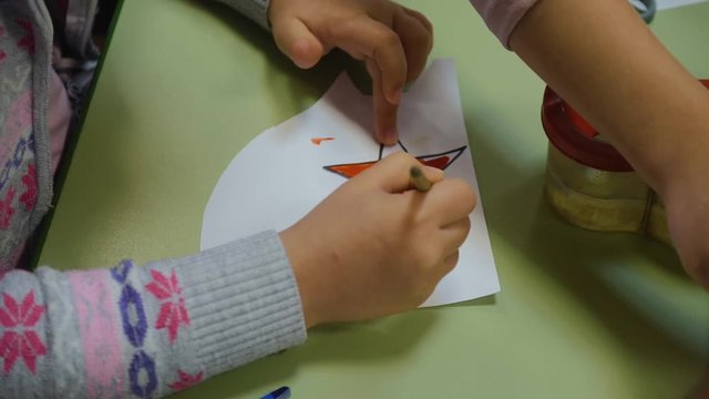 Children in kindergarten make drawings. Hands of children close-up. Children's creativity. Teamwork.