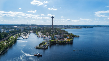 Panorama of Tampere city at summer day. Beautiful blue sky and clouds. Lakeside amusement park.