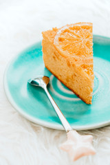 Orange cake slice on blue plate