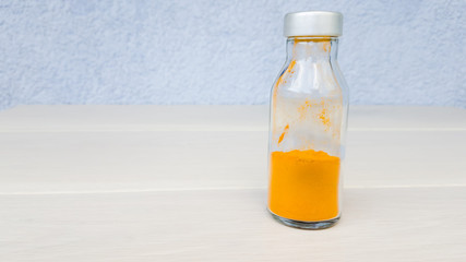 Turmeric jar with golden seasoning