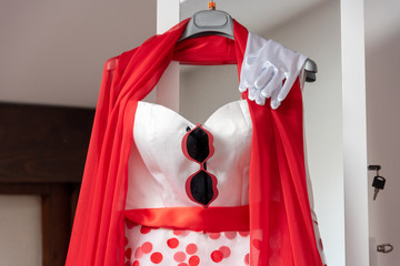 red wedding dress with glasses and white gloves