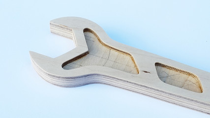Wrench. Wrench made of plywood. Wrench made of plywood on a light background