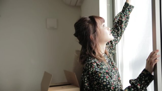 Young woman cleaning window