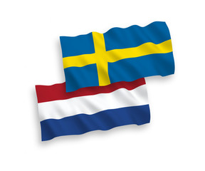 National vector fabric wave flags of Sweden and Netherlands isolated on white background. 1 to 2 proportion.