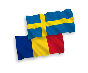 National vector fabric wave flags of Romania and Sweden isolated on white background. 1 to 2 proportion.
