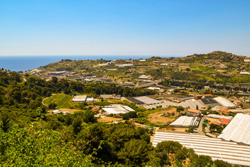 Obraz premium High angle panoramic view of the Armea Valley with greenhouses for the cultivation of flowers, a typical commercial activity of the area of Sanremo, Imperia, Liguria, Italy