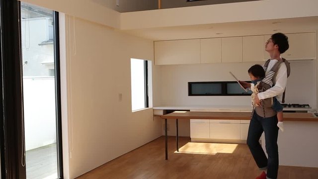 Family inspecting kitchen of open house