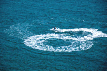 Naklejka premium The girl rides a water scooter. A young girl is resting on the sea. Leisure activities at sea.