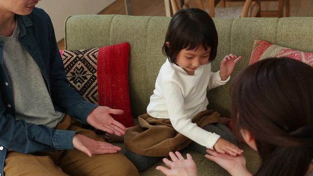 Parents playing with little daughter