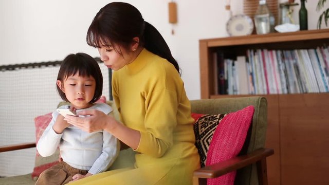 Mother and daughter watching video on&not;&dagger;smartphone