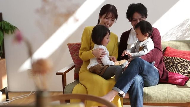 Parents playing with children in living room