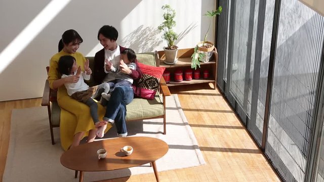 Parents playing with children in living room