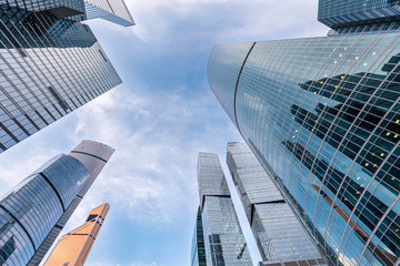 Wide angle view of modern skyscrapers in downtown district with blue sky and clouds