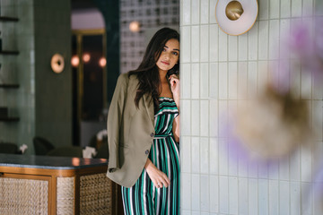 Portrait of a tall, slim, elegant and beautiful Indian Asian woman in an elegant jumper with a...