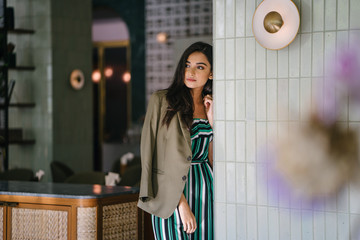 Portrait of a tall, slim, elegant and beautiful Indian Asian woman in an elegant jumper with a...