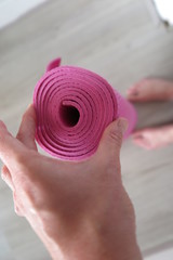 Hand holding yoga mat