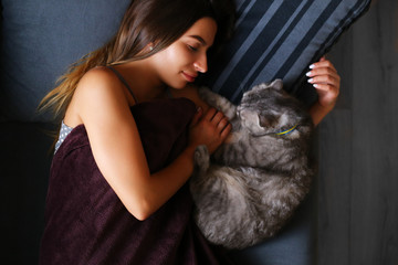 soft focused girl sleeping at home wit his cat 