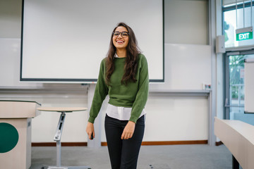 Portrait of a young, beautiful, attractive and intelligent Indian Asian woman wearing spectacles in...