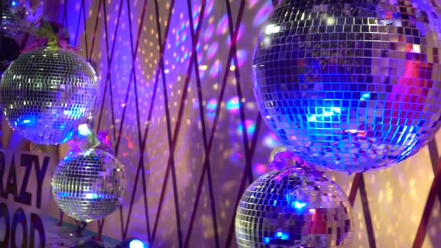 The four purple disco balls rotate. The symbol of 80s and 90s party time