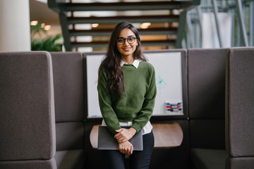 Portrait of a young, beautiful, intelligent and attractive Indian Asian MBA student smiling as she...