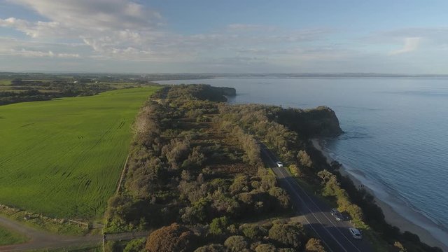 4k aerial footage along winding coastal road and countryside.