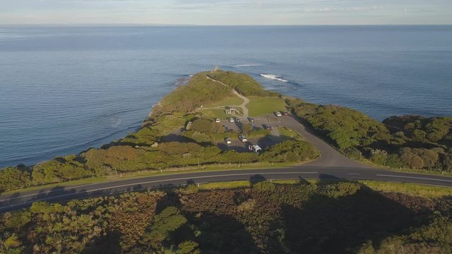 4k aerial footage along winding coastal road and countryside.