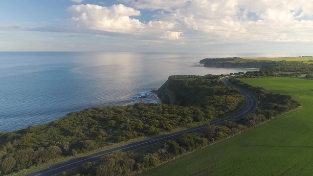 4k aerial footage along winding coastal road and countryside.