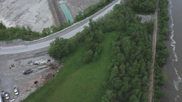 Drone flies between a river and a quarry in the Midwestern USA.  in summer, in 4K.