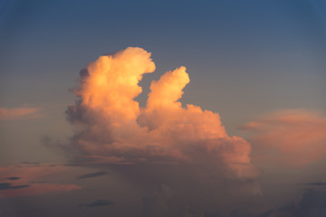 Evening sky with dramatic clouds over the sea with sculpted 3D cloudscape.