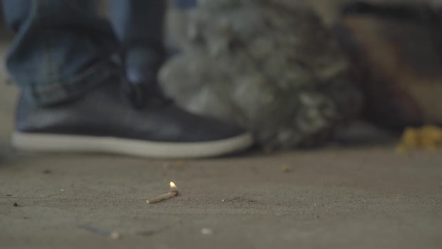 Two unrecognized boys playing with the matches in abandoned building. The match falling on the floor and kids running away. Concept of fire, flammability, non-compliance with safety rules.