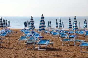 parasol and deckchairs  on the sandy beach of the resort in summ