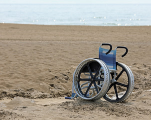 special wheelchair with big metal  wheels on the beach