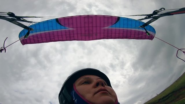 Close up of woman's face while flying the paraglider