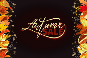 Autumn Sale banner. Hand lettering and a border of fallen leaves on black background.