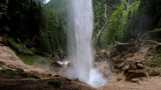 SLOWMO Falling misty water view under overhang of waterfall Pericnik