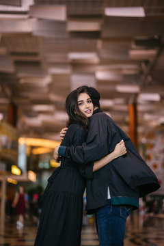 A Young And Attractive Indian Asian Woman Is Hugging Her Boyfriend In A Futuristic Airport During The Day. She Looks Sad At The Prospect Of Missing Him As He Goes Out Of Country.