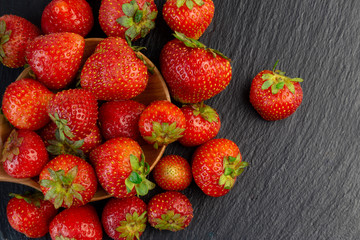 Strawberries in wooden bowl. Fresh nice strawberries on wooden table. Juice strawberry