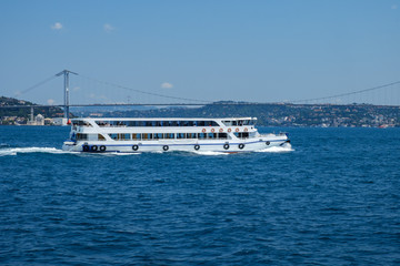 Istanbul, Turkey, Bosphorus Bridge and Uskudar Coast. Pleasure boats sail on the Bosphorus