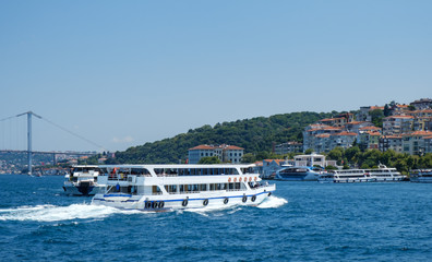 Istanbul, Turkey, Bosphorus Bridge and Uskudar Coast. Pleasure boats sail on the Bosphorus