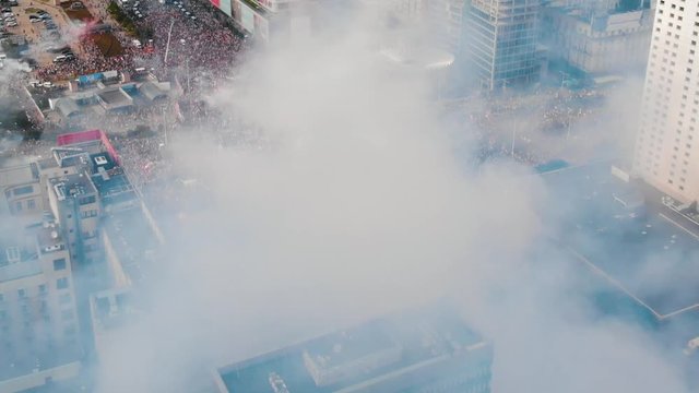 Godzina W Drone dolly in shot through the smoke rising from burning torches. City stopped for a minute to pay respect to fallen heroes that fought for freedom in 1944 during the Warsaw Uprising