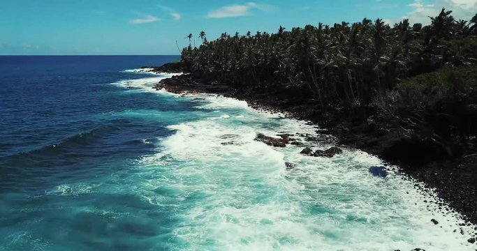 Black Sand Beach at Isaac Hale Beach Park (Pohoiki) on Big Island of Hawaii - Ascending Aerial View Panning Down. 4k.