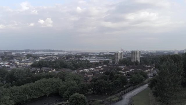 Everton valley cityscape residential property & shipyard coastline in the distance. Aerial view descending over park.