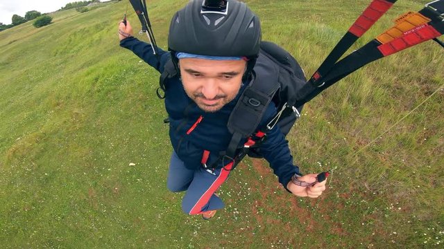 Man is flying the paraplane above the earth