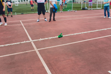 People playing tug of war during obstacle training course in boot camp.