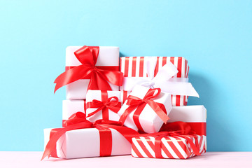 Set of beautifully wrapped gift boxes on a colored background 