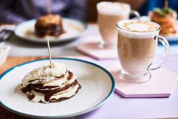 Closeup of chocolate cake in a cafe. desserts with latte in a cafe