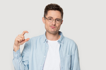 Headshot portrait guy showing with fingers something small